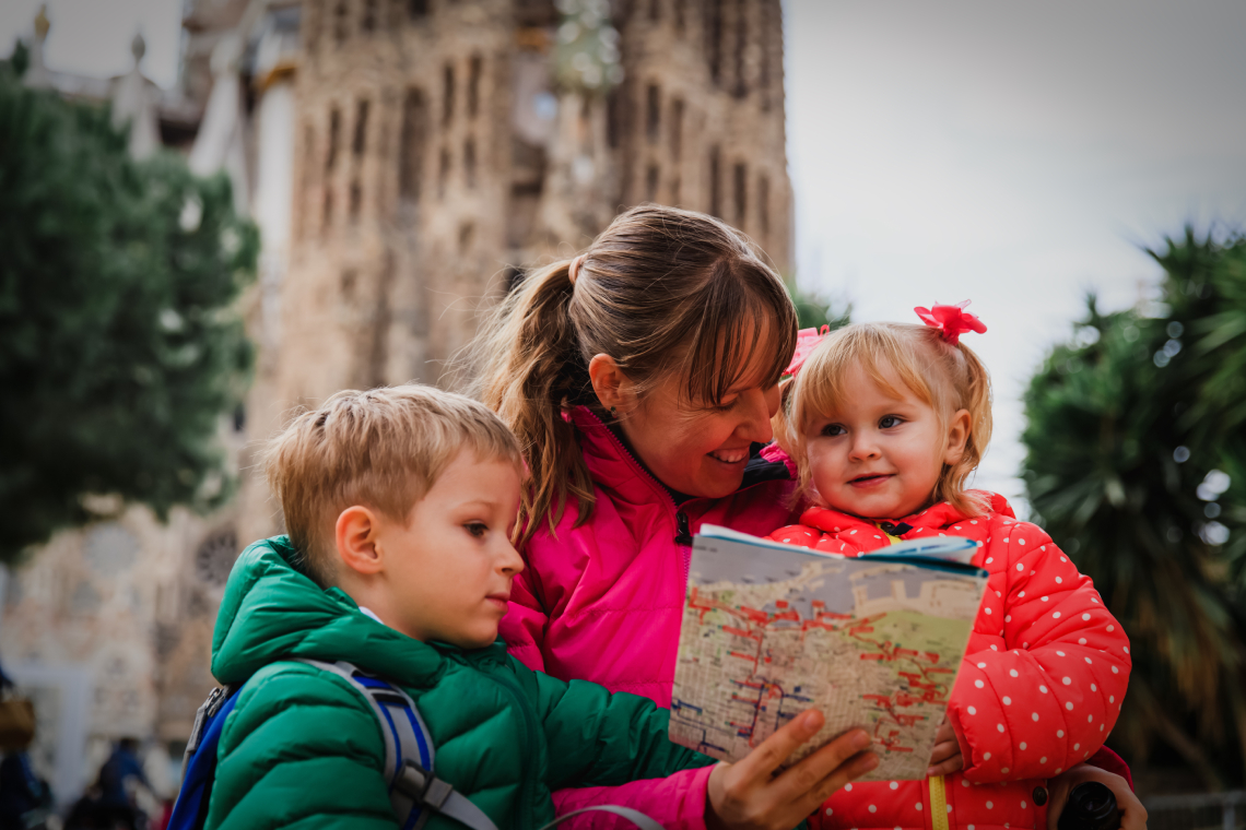 A mother with two small children visiting Barcelona with the Sagrada Família in the background