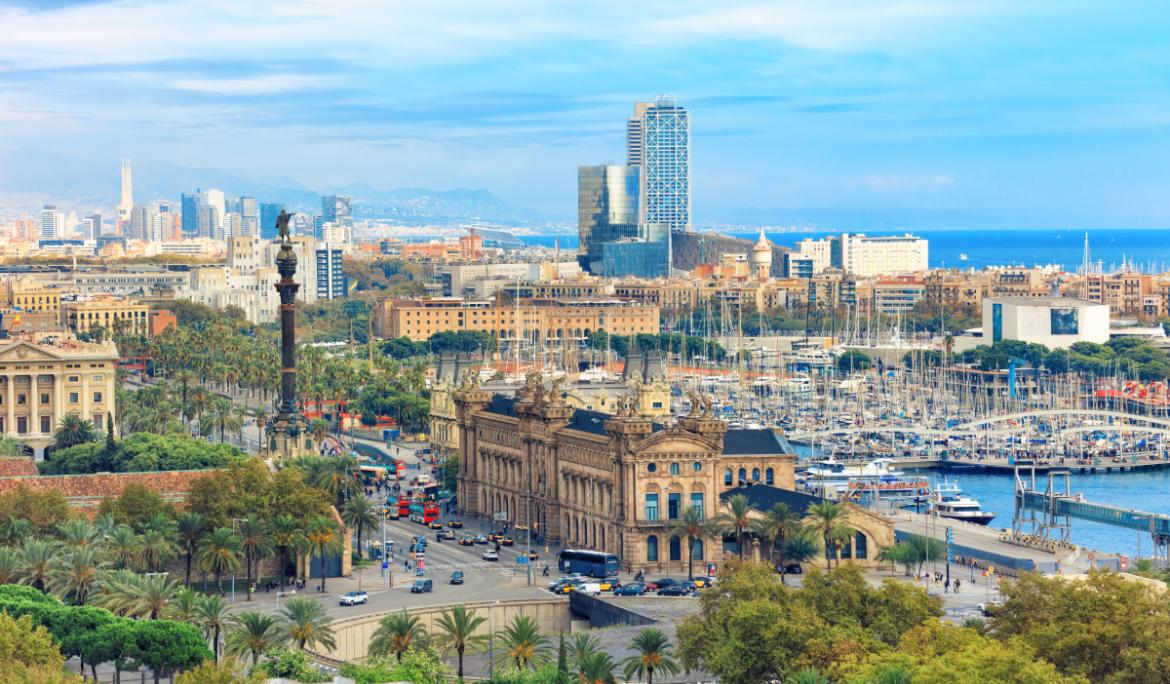 View of Barcelona’s skyline from Montjuïc, looking toward the port and the Mediterranean Sea.