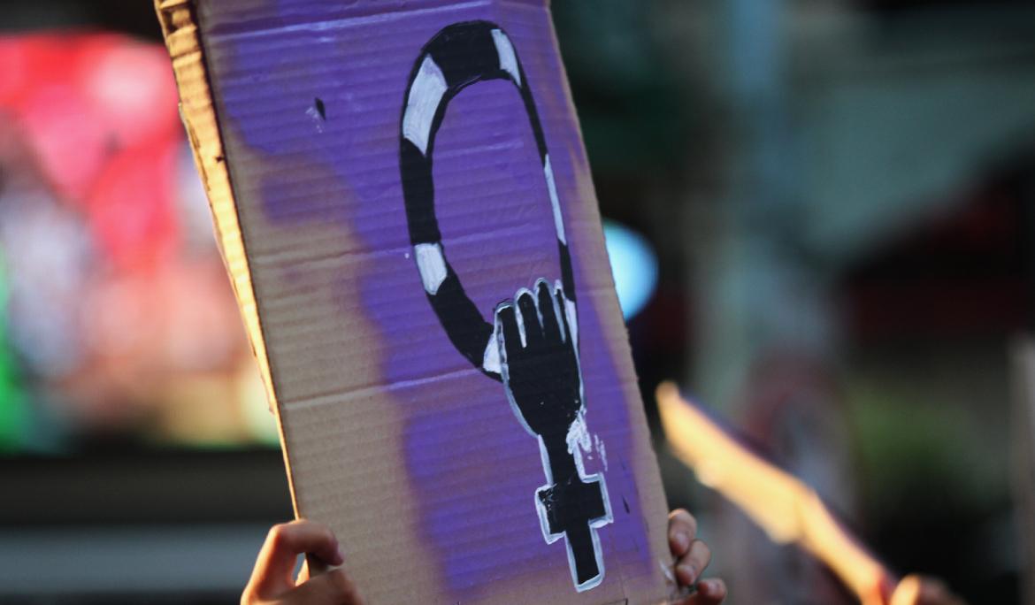 Pancarta seen on 8M in Barcelona with a painted illustration of the female symbol in purple.