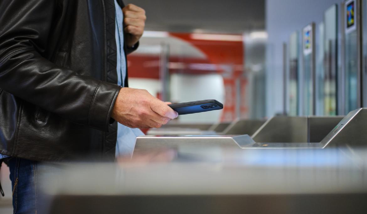 A man validates his ticket at the Barcelona metro station.