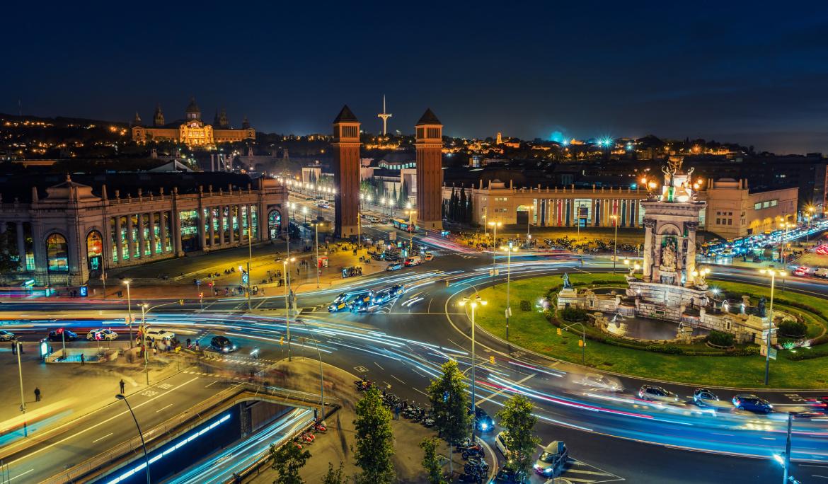 Barcelona de nit amb les llums dels cotxes que passen i deixen rastres lluminosos borrosos.