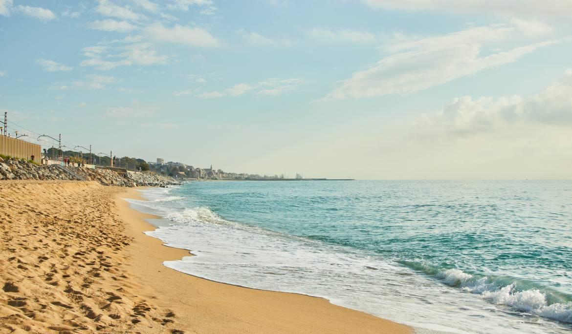 Montgat beach with gold sand and blue waters