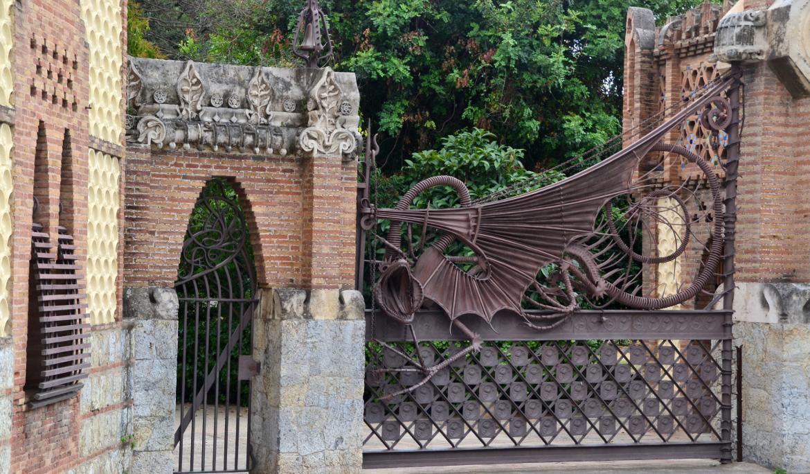 Close-up image of ornate modernist wrought ironwork and decorative gate details in Barcelona.