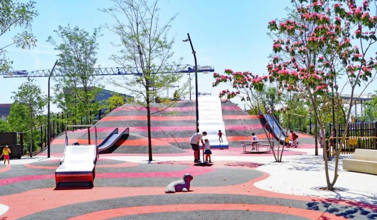 Wide shot of Glòries Park with children playing